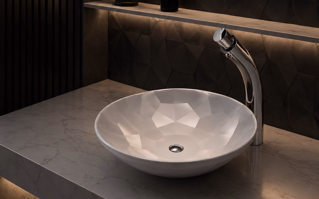 Pent faceted white round countertop basin with tall chrome mixer on a marble vanity
