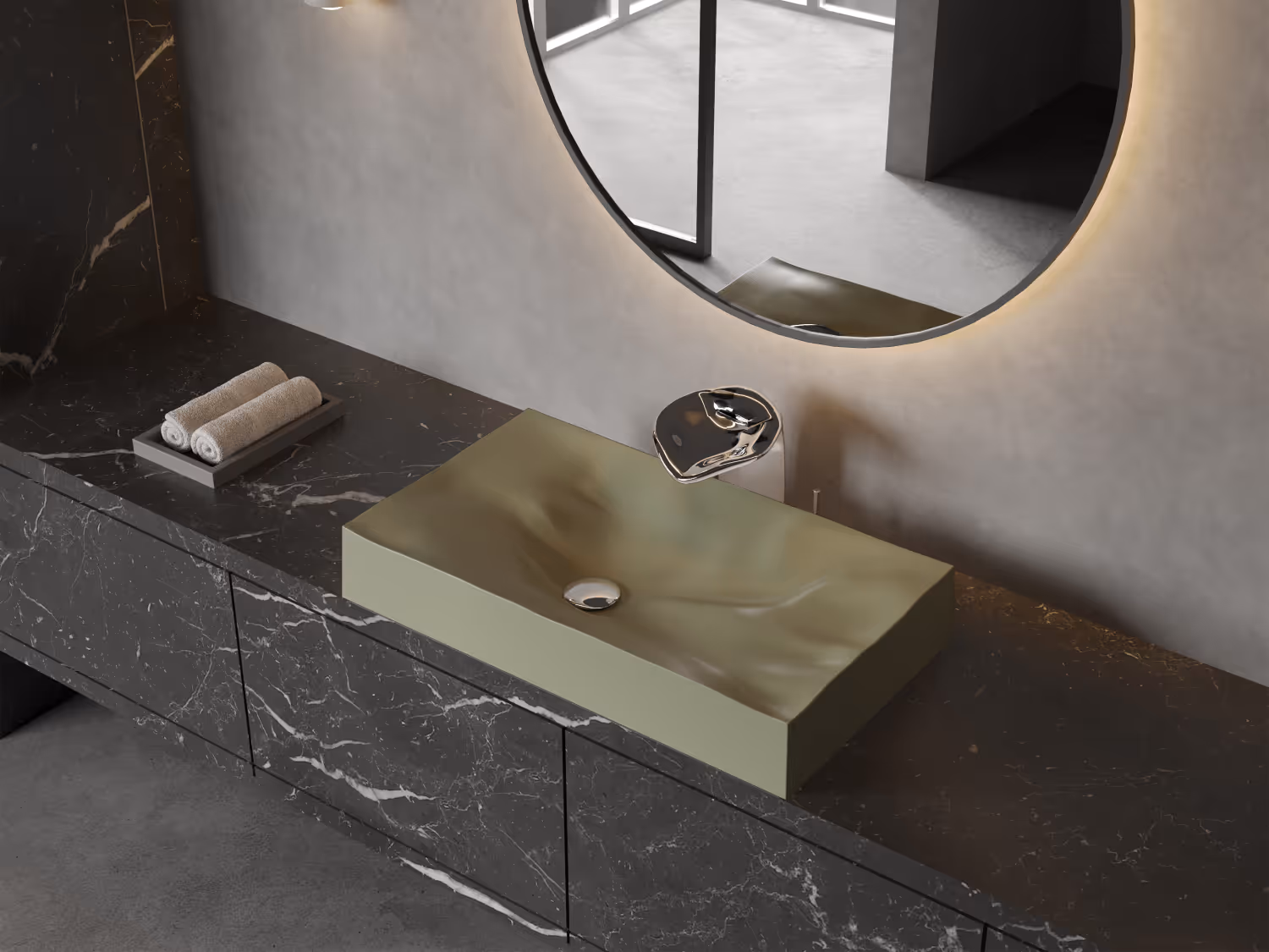 Olive green rectangular basin on a black marble vanity below a round backlit mirror