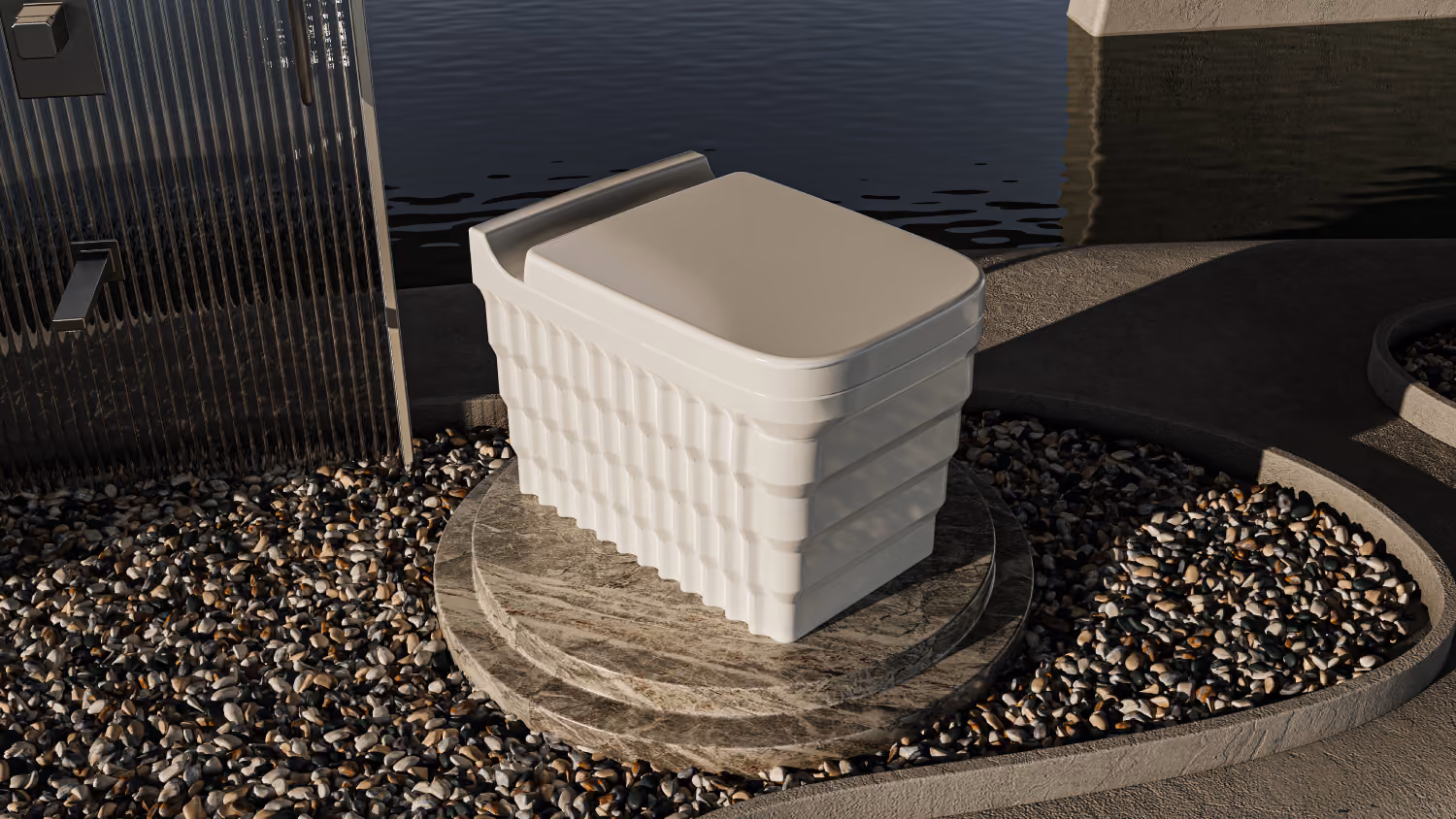 White ribbed square toilet on a stone plinth set in pebbles beside water