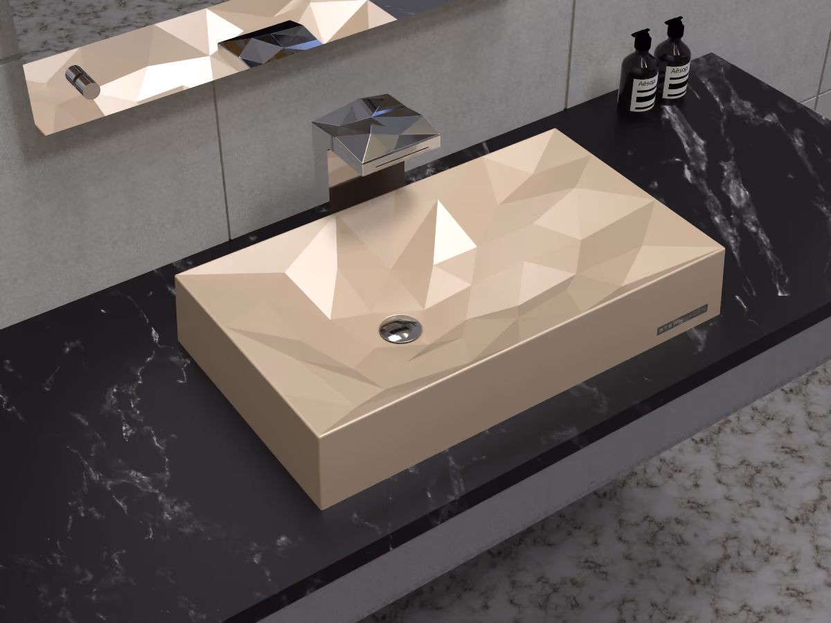 Beige faceted rectangular washbasin with chrome tap on a black marble countertop
